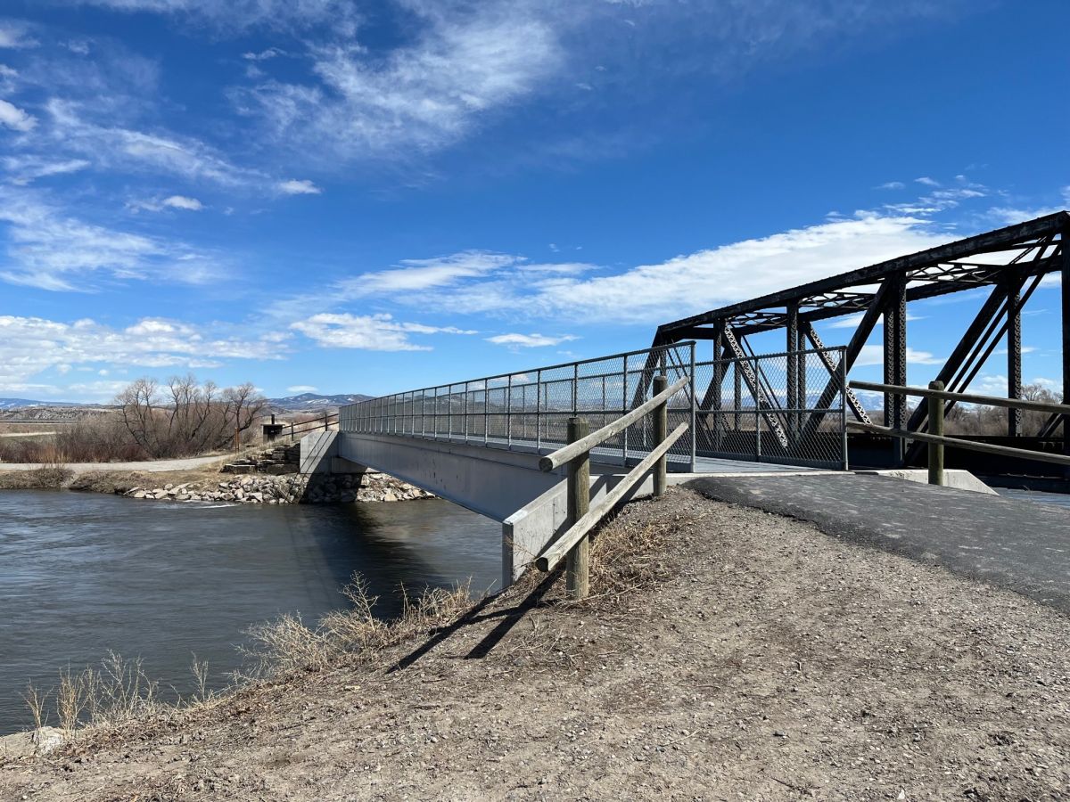 Image of pedestrian bridge crossing over the Madison River so that one can continue on towards the Headwaters State Park.